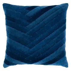 a blue pillow with wavy lines on the front and back, sitting against a white background