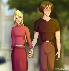 two people holding hands while walking down the street