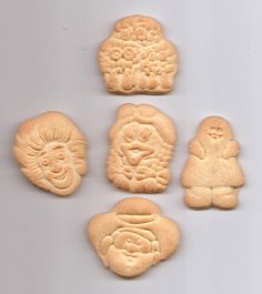 six cookies with faces and eyes are arranged in the shape of animals