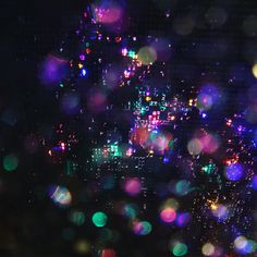 blurry image of city lights and raindrops at night