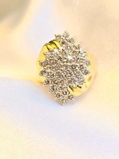 Thick and sparkly vintage gold ring.  Clustered round natural diamonds across the front forming a marquise like shape. approximately 1.5 TCW, imperfect diamonds with visible inclusions. Very gorgeous cocktail/ statement ring made from 14k solid yellow gold face of the ring is 23mm tall x 16mm wide Size US 7, sizable 2 +/- sizes weighs 7.4 grams Ships free out of Southern California Please expect signature delivery Dazzling Marquise Diamond Ring In Diamond White, Dazzling Diamond White Marquise Cut Diamond Ring, Dazzling Marquise Diamond White Ring, Gold Marquise Diamond Ring With Vvs Clarity, Dazzling Cubic Zirconia Cluster Ring Marquise Cut, Sparkling Cluster Diamond Ring, Gold Marquise Cluster Ring With Brilliant Cut, Marquise Cluster Ring With Diamond Accents In Cubic Zirconia, Classic Gold Sparkling Rings