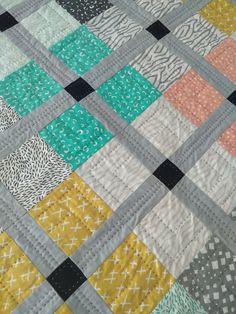 a close up of a quilt made with squares and dots on it's edges