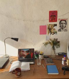 a wooden desk topped with a laptop computer