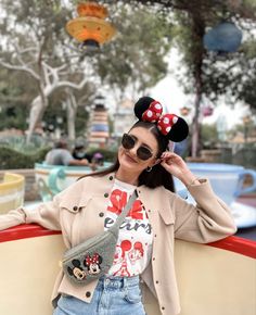 a woman wearing sunglasses and a mickey mouse shirt