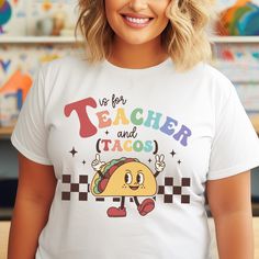 Show off your personality and passion with our delightful "T is for Teachers and Tacos" T-shirt. Perfect for any educator who loves to teach and enjoys a good taco, this shirt is a great addition to your wardrobe or a thoughtful gift for a special teacher in your life.  Details: - 100% Cotton Comfort: Made from high-quality, breathable 100% cotton, this T-shirt ensures a comfortable and soft feel all day long. - Available in 4 Colors to match your style - Unique Design: The playful design featur White Novelty T-shirt With Text Print, White Novelty T-shirt With Letter Print, Happy Taco, Teacher Must Haves, Back To School Gift, Teacher Appreciation Week, School Gift, Gift Teacher, Back To School Gifts