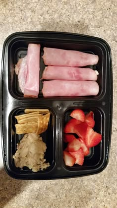 a plastic container filled with food on top of a table