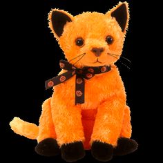 an orange stuffed animal sitting on top of a white floor next to a black background