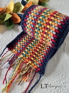 a multicolored scarf laying on top of a table