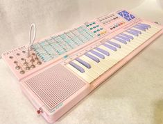 a pink electronic keyboard sitting on top of a table