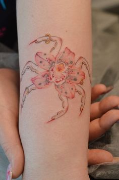 a woman's arm with a crab tattoo on it