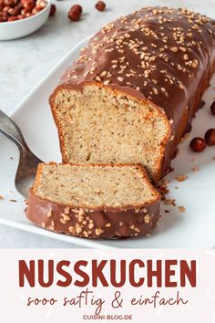 a close up of a loaf of bread on a plate with nuts in the background