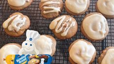 some frosted cookies are sitting on a cooling rack