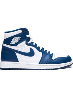 the air jordan 1 mid is available in blue and white, with an emblem on the upper