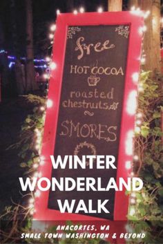 a sign with lights around it that says winter wonderland walk and free hot cocoa, roasted chestnuts & crushed s'mores