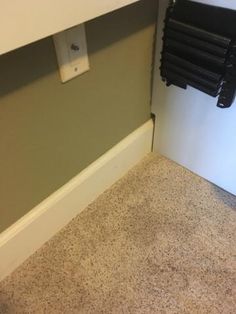 the corner of a room with a radiator and towel rack