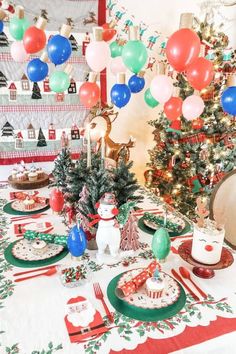 a table set for christmas with balloons and decorations