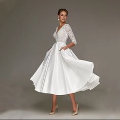 a woman wearing a white dress and heels