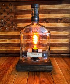 a glass bottle with a light inside on a wooden table