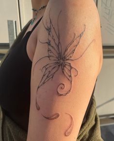 a woman's arm with a butterfly tattoo on the left side of her arm