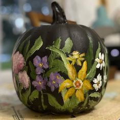 a painted pumpkin sitting on top of a table