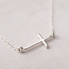 "Sterling Silver Sideways Cross Necklace Dainty and minimalist sideways cross necklace. Lightweight, perfect for everyday wear. Wear it as a choker, or choose a longer chain for a classic look. FEATURES: * dainty cross hangs in the middle of the necklace, * comes on a delicate flat cable chain, finished with a spring clasp closure. MEASUREMENTS: * sterling silver cross is 6/8\" wide and 3/8\" high (19x10 mm) * sterling silver cable chain is 1.4 mm wide * the necklace shown on a life size mannequ Silver Minimalist Cross Necklace With Clavicle Chain, Minimalist Sterling Silver Cross Necklace With Clavicle Chain, Minimalist Cross Necklace With Clavicle Chain, Adjustable Minimalist Cross Necklace, Minimalist Cross Necklace For Everyday, Everyday Minimalist Cross Pendant Necklace, Minimalist Daily Wear Cross Pendant Necklace, Minimalist Everyday Cross Necklace, Minimalist Cross Necklace With Delicate Chain