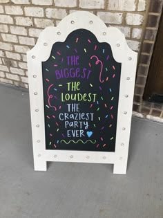 a chalkboard sign that says the biggest loudest the craziest party ever