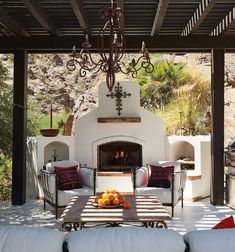 an outdoor living area with furniture and a fireplace