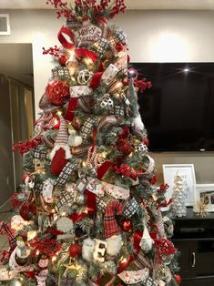 a christmas tree decorated with red and silver ornaments