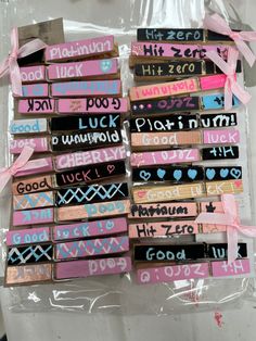 there are many different colored wooden signs on the plastic wrapper that is wrapped in pink and blue