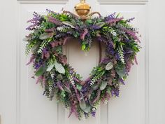 a heart shaped wreath hangs on the front door