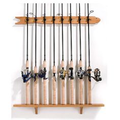 fishing rods and reels mounted to a wall with wooden brackets on the bottom shelf