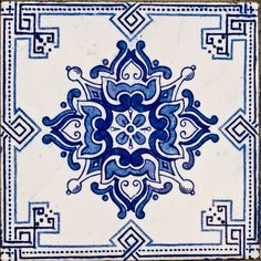 a blue and white tile with an intricate design on the bottom corner, in square shape