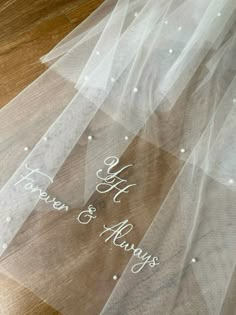 a wedding veil with the words happily married and always written in white ink on it