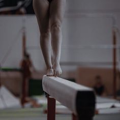 a person on a balance beam in a gym