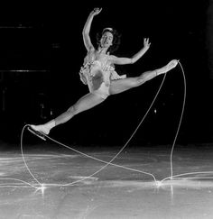 an old photo of a woman in the air with a string attached to her leg