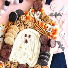 a house made out of cookies, candy and marshmallows on a table