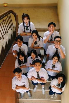 a group of young people standing on top of stairs