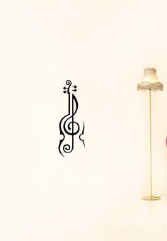 a room with a lamp, chair and musical note wall decal