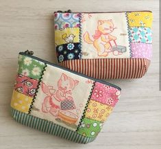 two small zippered pouches are sitting on a white surface, one has an image of a cat and the other has flowers