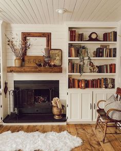 a living room filled with furniture and a fire place next to a bookshelf