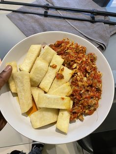 a white plate topped with sliced up bananas and other food on top of a table