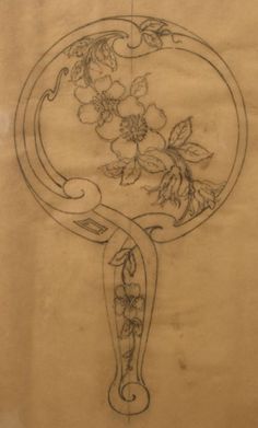 a drawing of flowers and vines in a frame on a piece of paper with writing underneath it