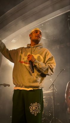 a man standing on stage holding a microphone