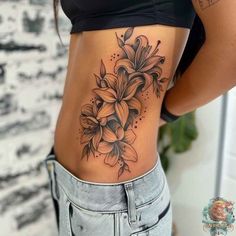 a woman with a flower tattoo on her stomach