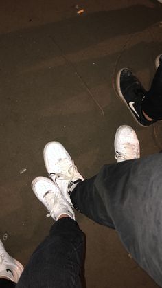 two people standing next to each other with white shoes