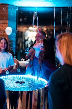 some people are standing around with bubbles in the air