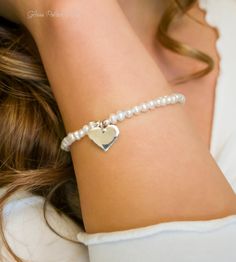 Fall in love all over again with this glimmering silver heart and pearl bracelet....................... White/ Ivory freshwater pearls are AA quality and measure about 2mm Shiny sterling heart measures about 13mm Chain is dainty 925 sterling silver Bracelet is adjustable (choose your size) Bracelet closes with a sterling silver spring clasp This is a handmade item and made for you after the order is placed PACKAGINGAll Jewelry is carefully packaged for a safe arrival and is secured in a jewelry Silver Spring, Sterling Silver Bracelet, Sterling Silver Heart, Heart Bracelet, Silver Heart, Pearl Bracelet, Sterling Silver Bracelets, Diamond Bracelet, Fresh Water