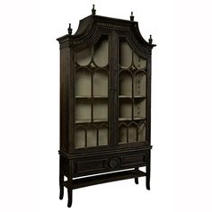 an old fashioned china cabinet with glass doors and carvings on the front, in dark wood