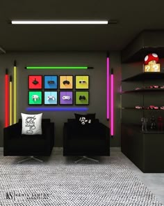 a living room with two black couches and colorful pictures on the wall