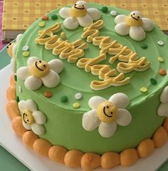 a green cake with yellow and white decorations